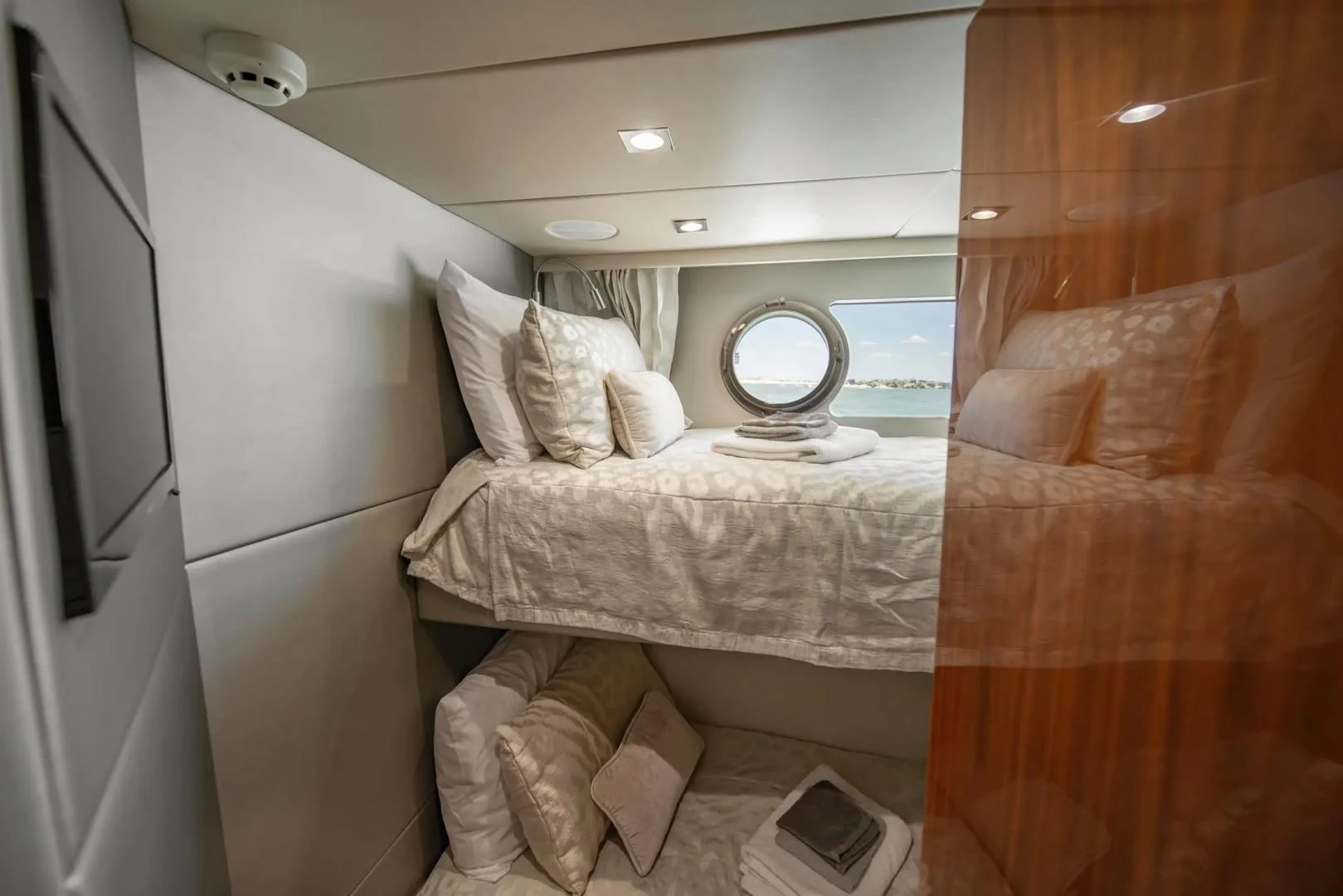 a bed with a mirror above it aboard LIQUIDITY Yacht for Sale