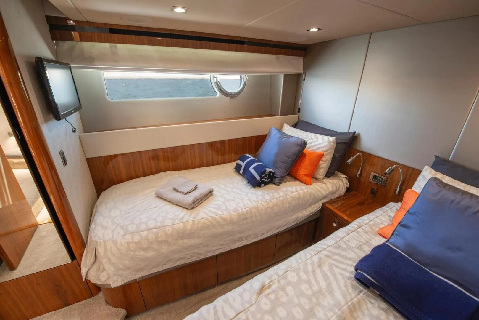 a room with a bed and a television aboard LIQUIDITY Yacht for Sale