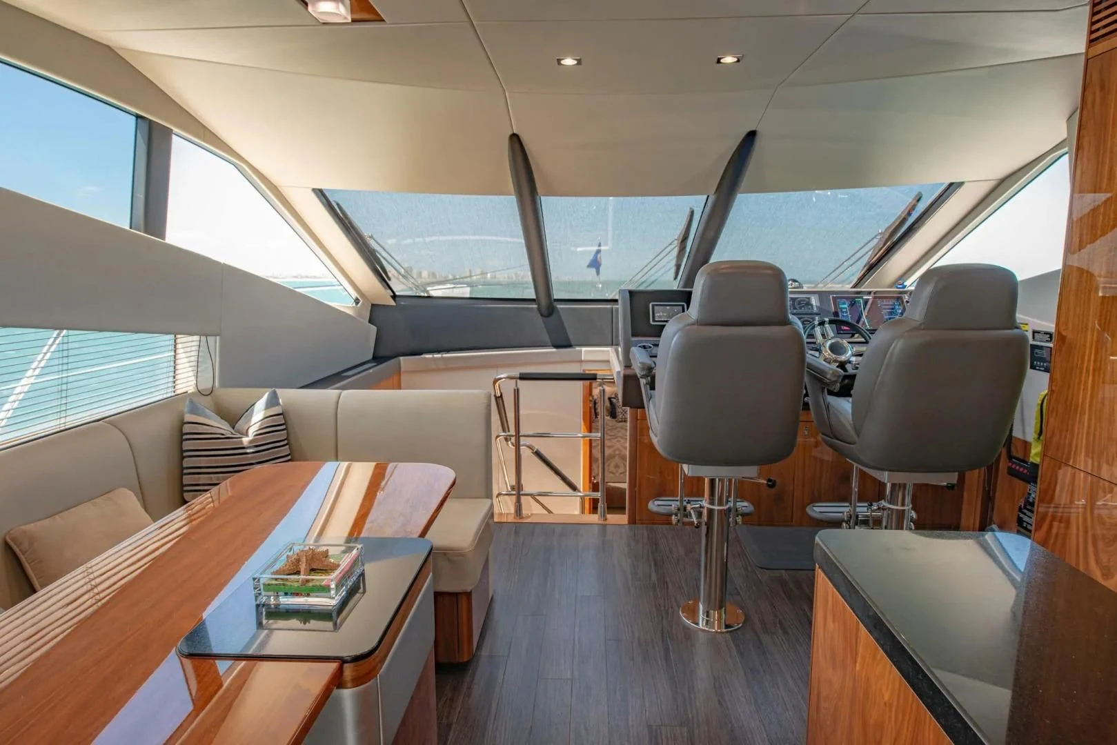 inside of a vehicle with chairs and tables aboard LIQUIDITY Yacht for Sale