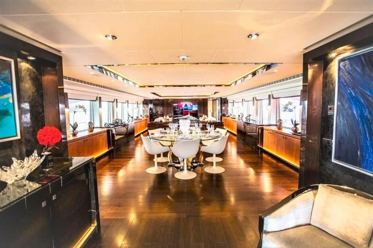 a room with tables and chairs aboard ROCKET Yacht for Sale