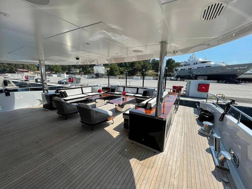 a deck with a deck and chairs aboard ROCKET Yacht for Sale