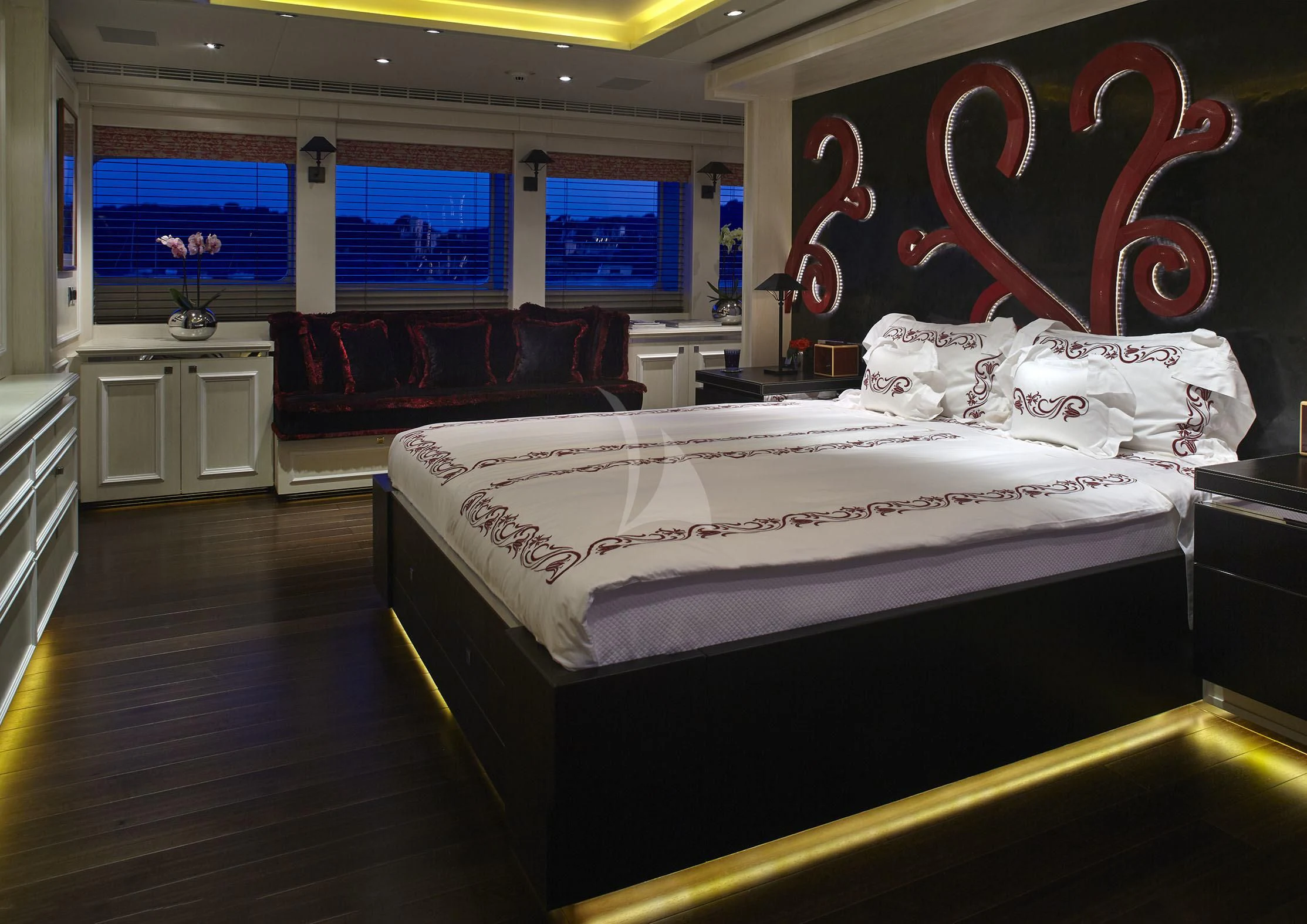 a room with a bed and a couch aboard ROCKET Yacht for Sale