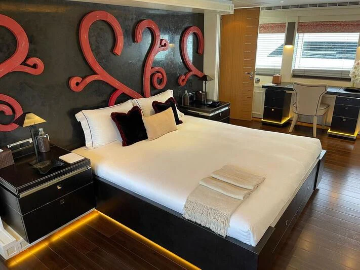 a room with a bed and a desk aboard ROCKET Yacht for Sale