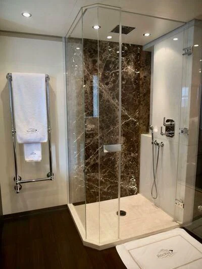 a bathroom with a glass shower aboard ROCKET Yacht for Sale