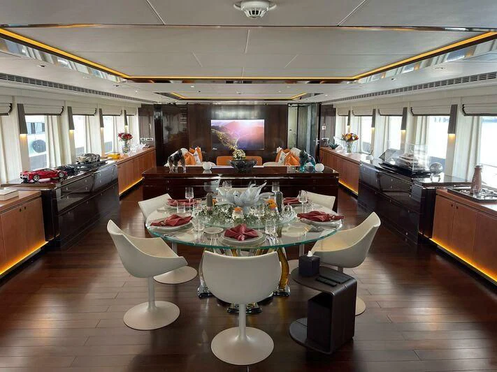 a dining room with tables and chairs aboard ROCKET Yacht for Sale