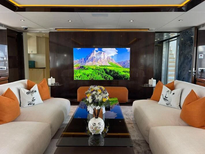 a living room with a large screen aboard ROCKET Yacht for Sale
