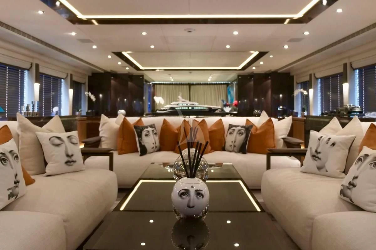 a living room with a large sofa and a coffee table aboard ROCKET Yacht for Sale