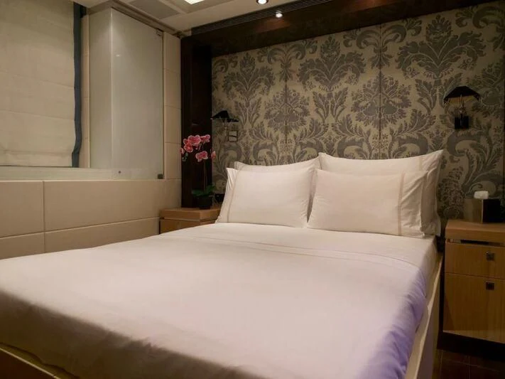 a bed with white sheets aboard ROCKET Yacht for Sale