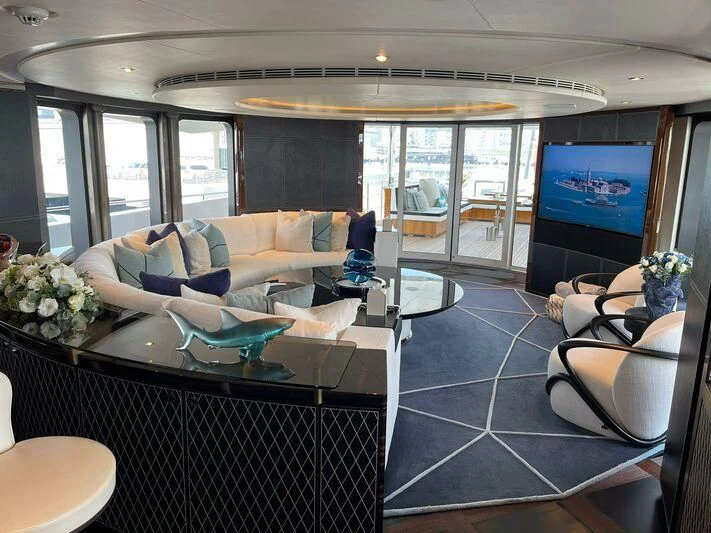 a living room with a large glass door aboard ROCKET Yacht for Sale