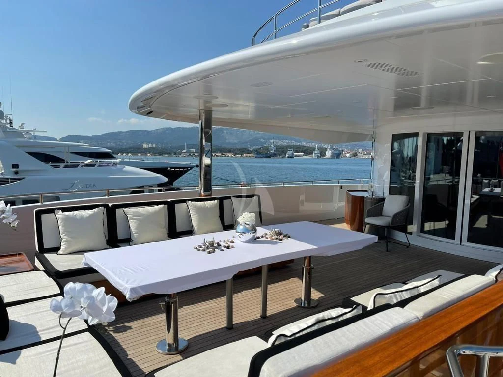 a room with a table and chairs aboard ROCKET Yacht for Sale