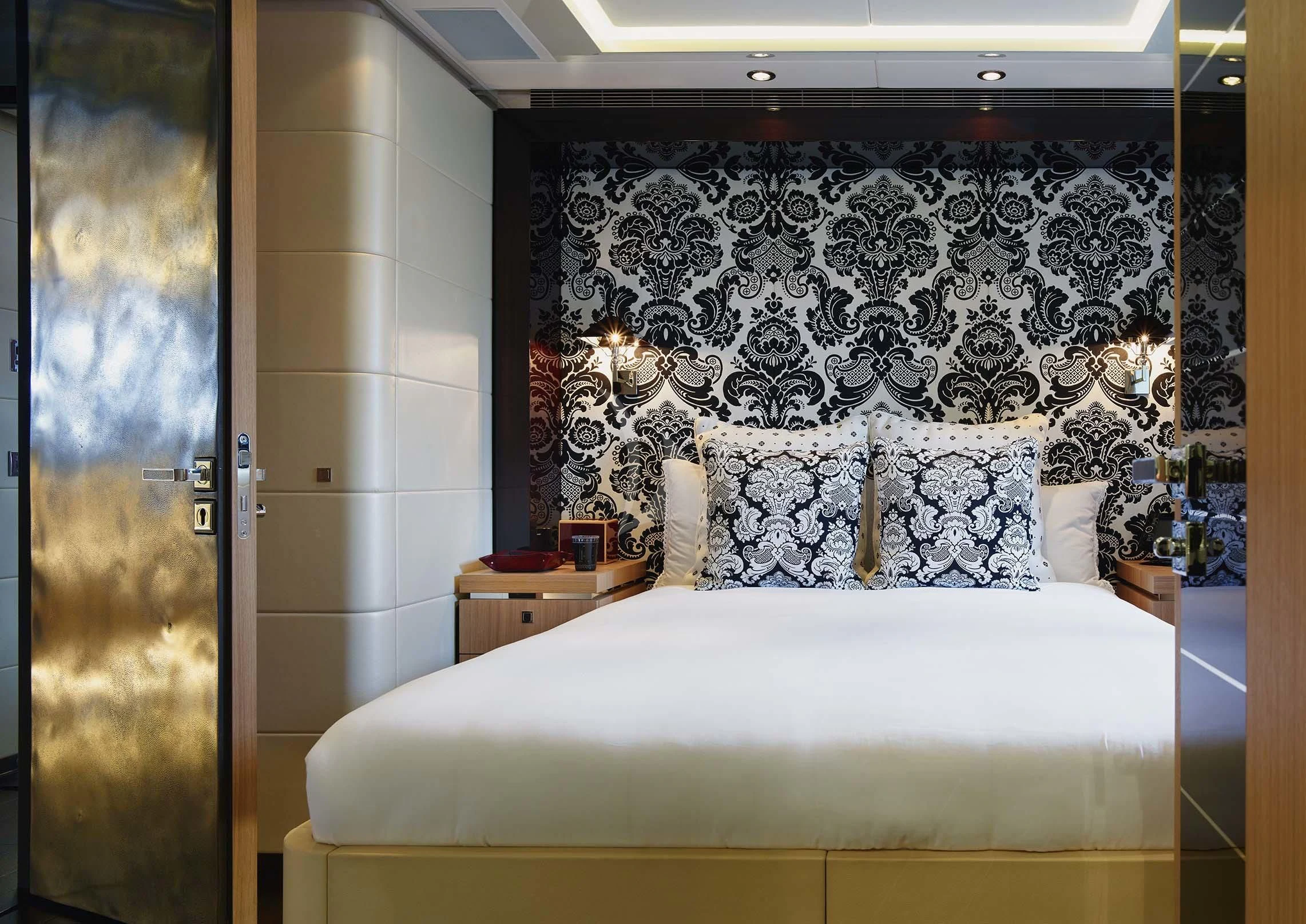 a bed with a painting on the wall aboard ROCKET Yacht for Sale