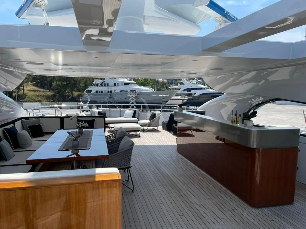 a room with a table and chairs aboard ROCKET Yacht for Sale