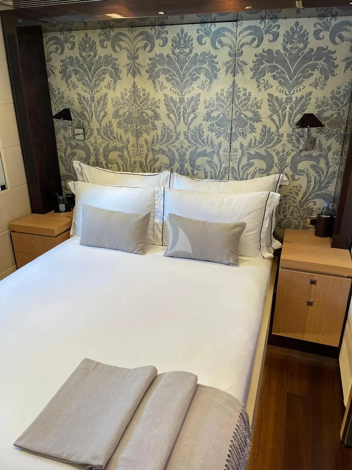 a bed with a white comforter aboard ROCKET Yacht for Sale