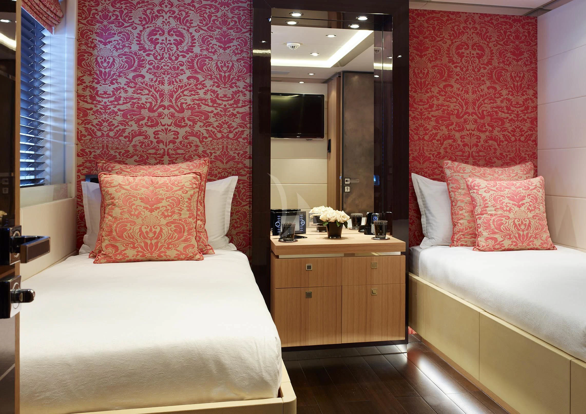 a bedroom with a bed and a mirror aboard ROCKET Yacht for Sale
