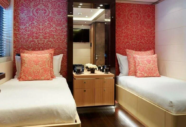 a bedroom with a bed and a mirror aboard ROCKET Yacht for Sale