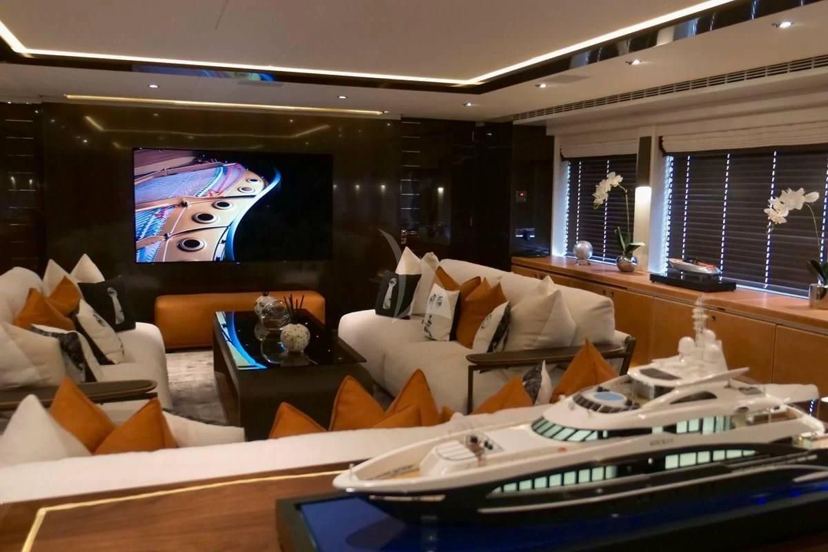 a living room with a large screen aboard ROCKET Yacht for Sale