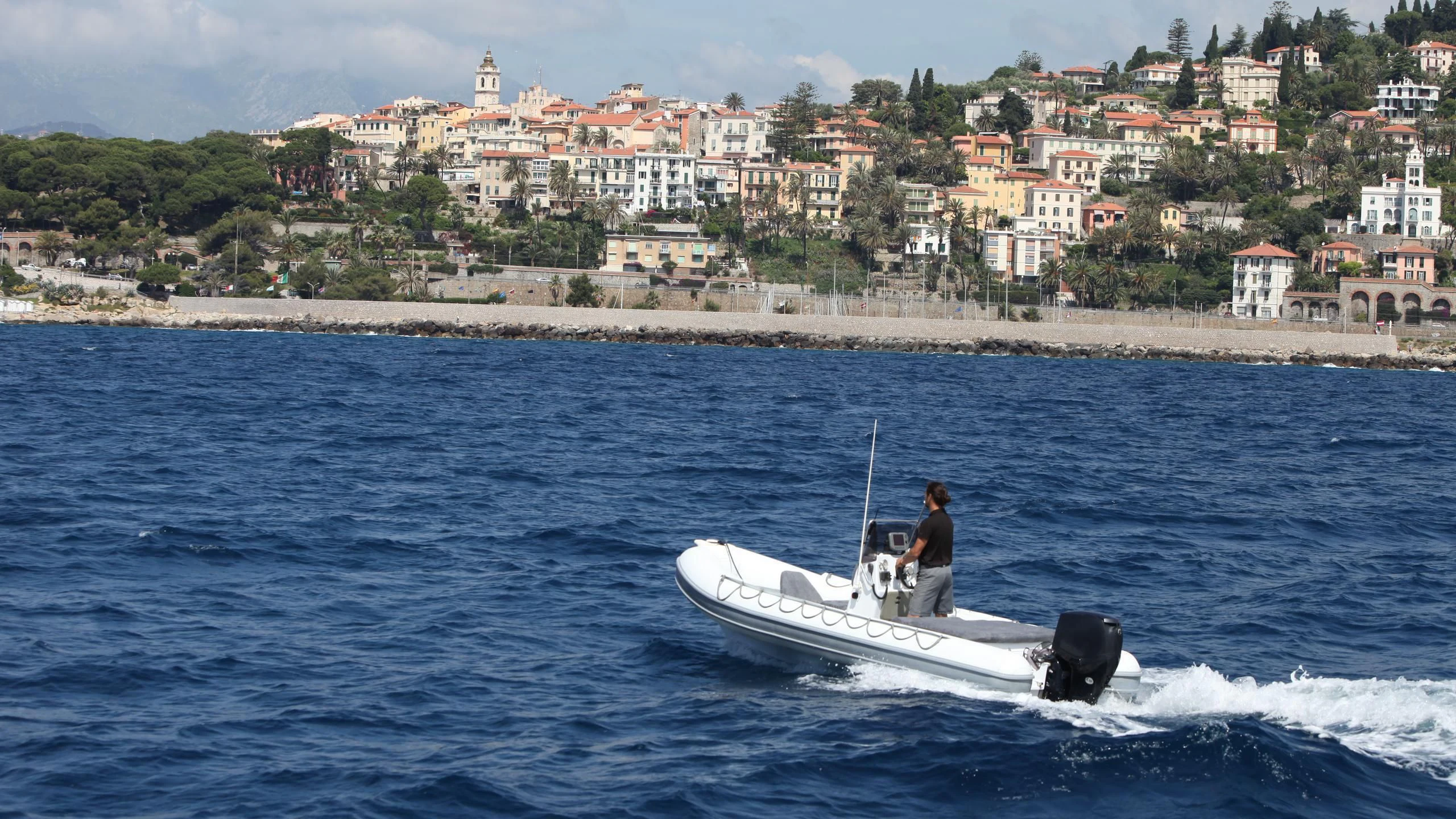 a person driving a boat on the water aboard DIONEA Yacht for Sale
