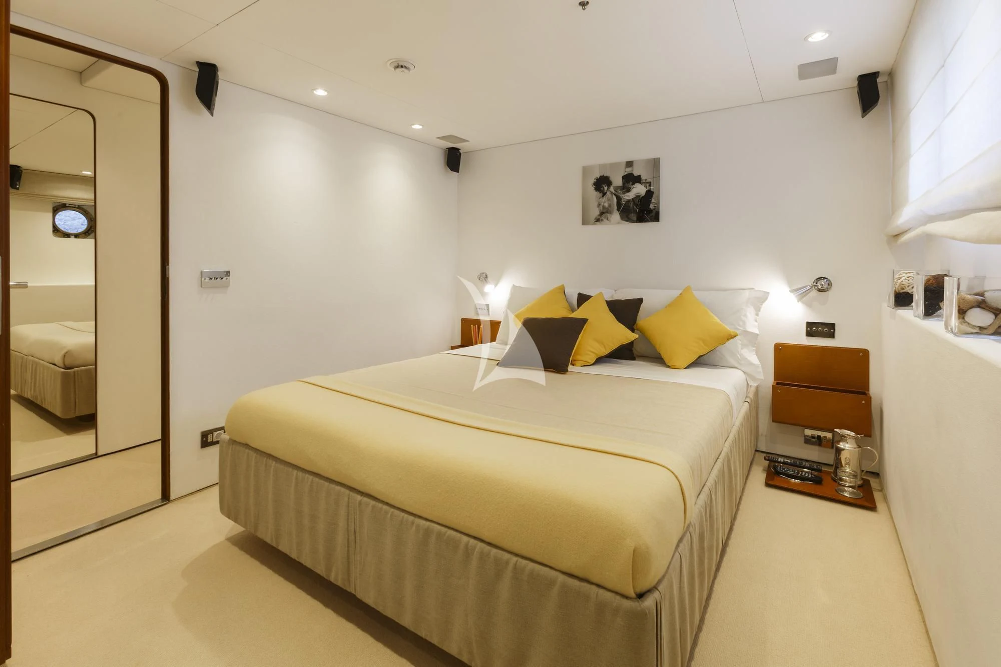 a bedroom with a bed and a mirror aboard DIONEA Yacht for Sale