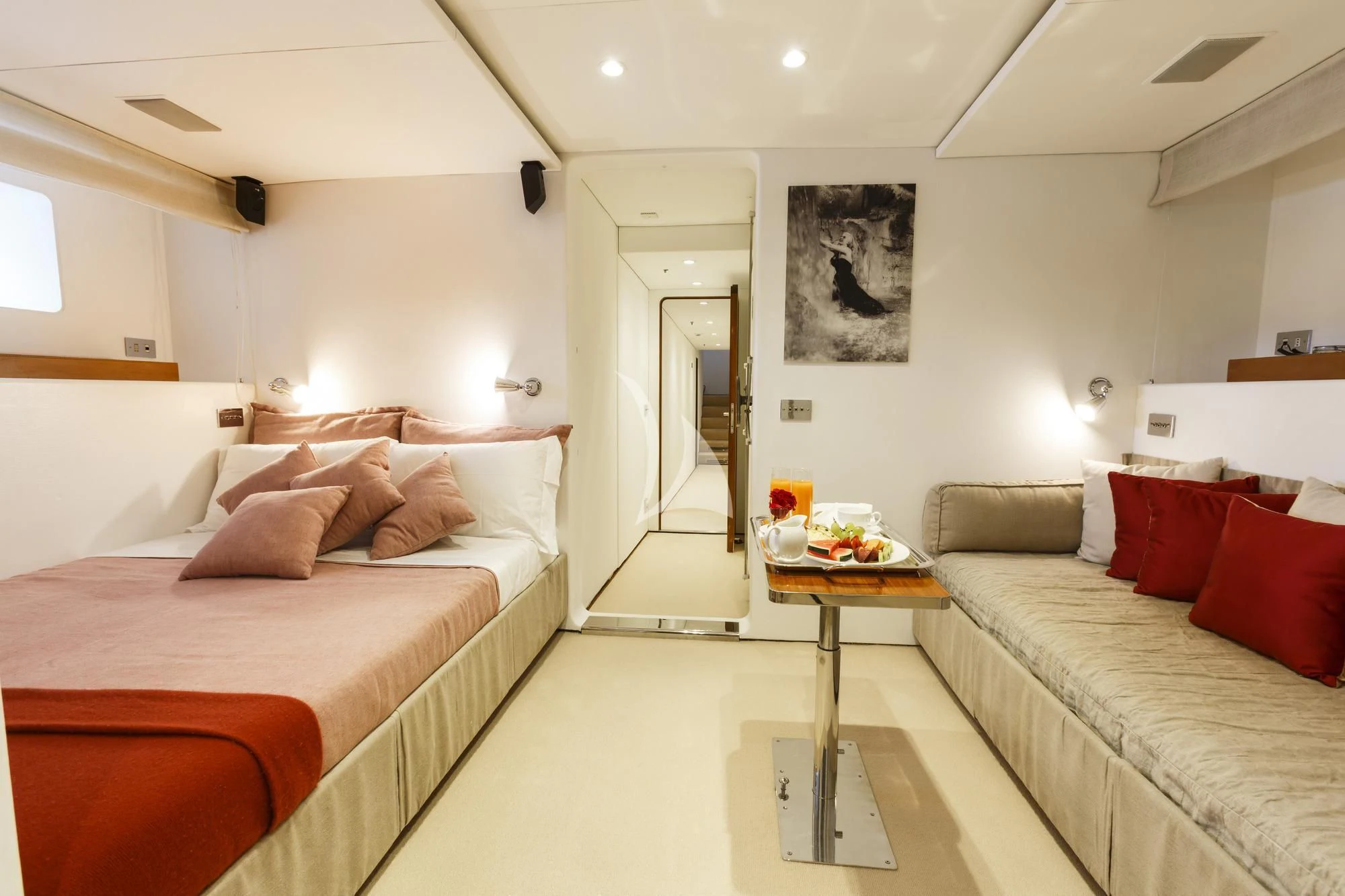 a bedroom with a bed and a table aboard DIONEA Yacht for Sale