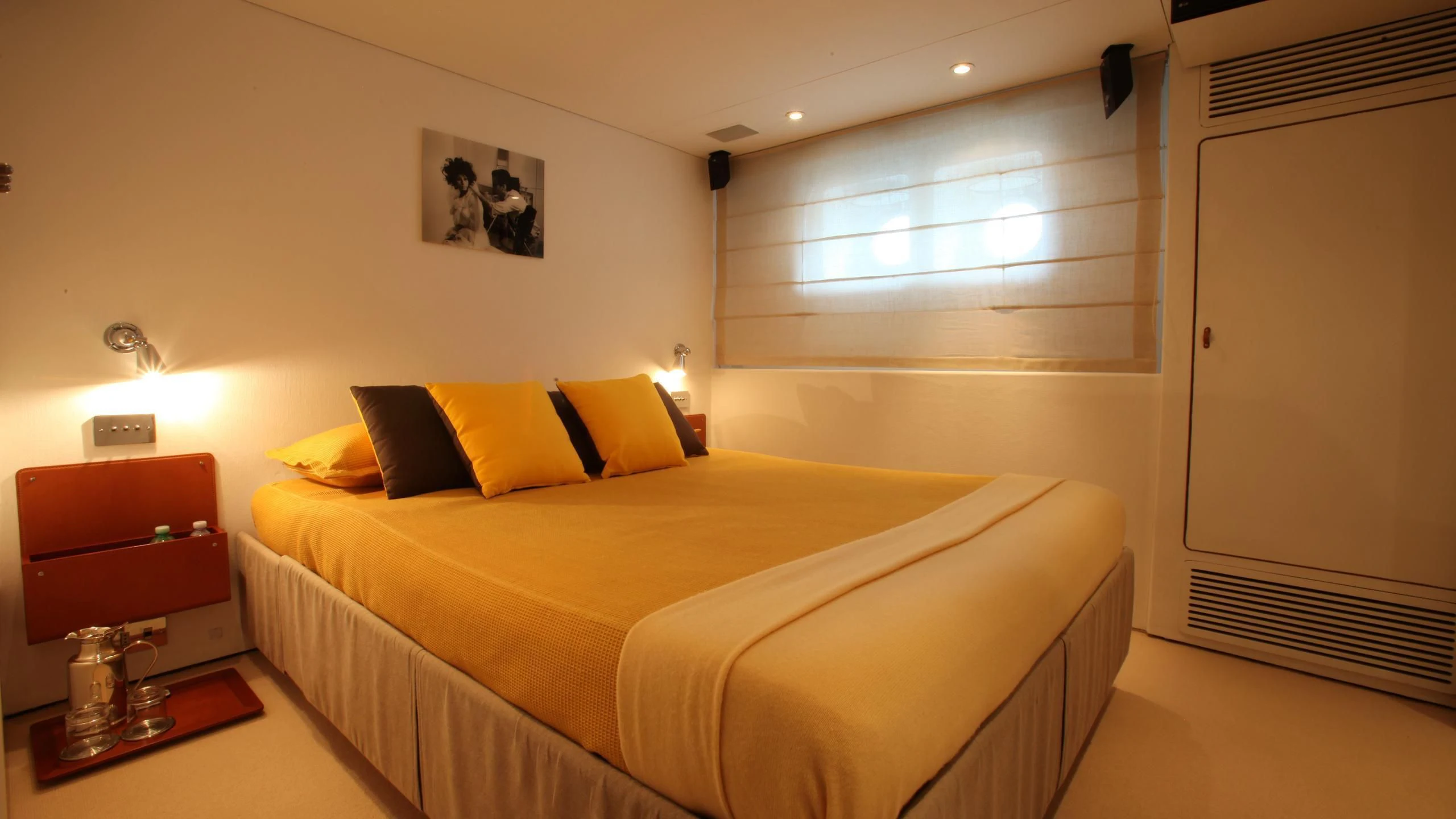 a bedroom with a bed and a desk aboard DIONEA Yacht for Sale