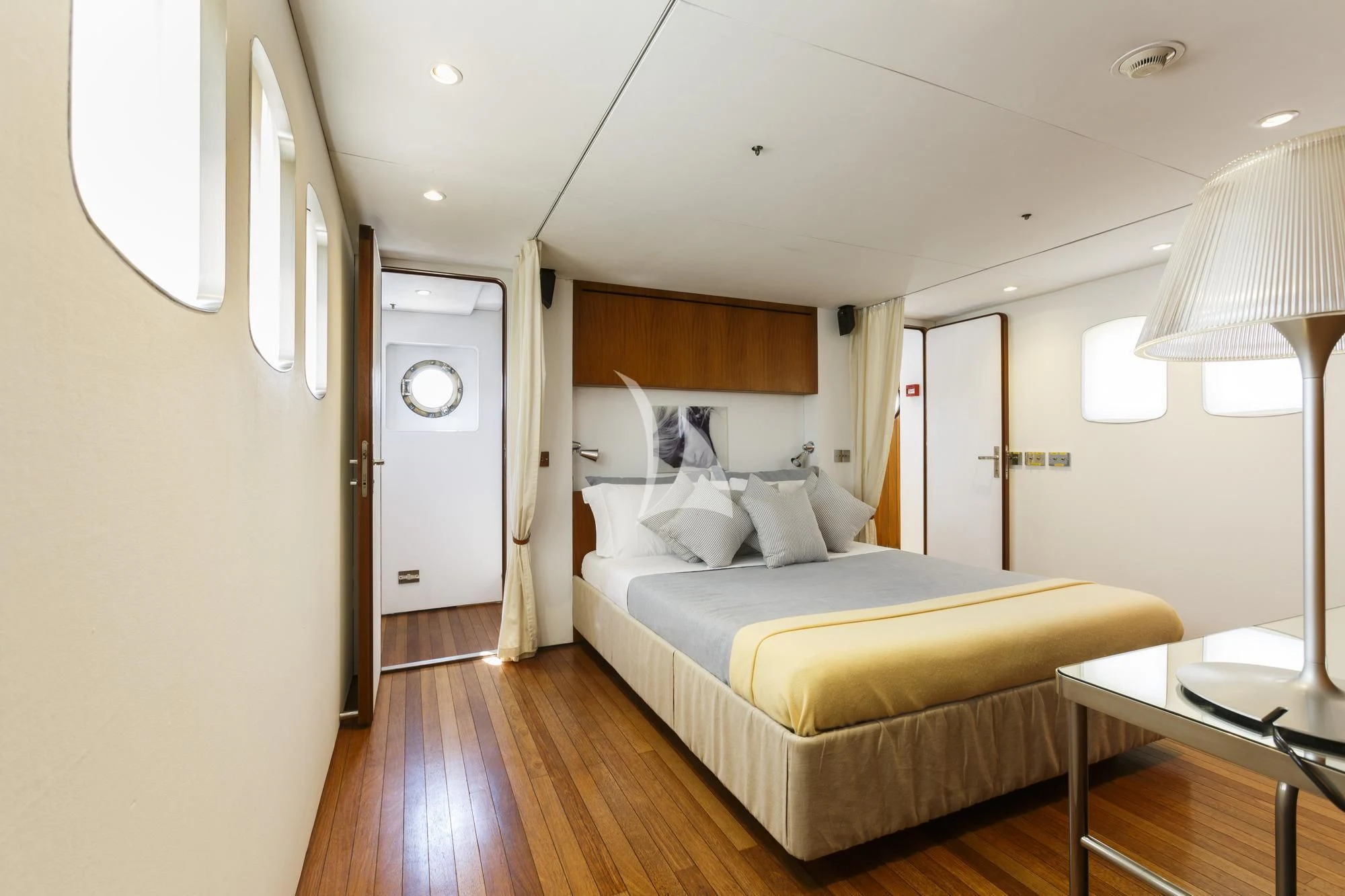 a bedroom with a bed and a table aboard DIONEA Yacht for Sale