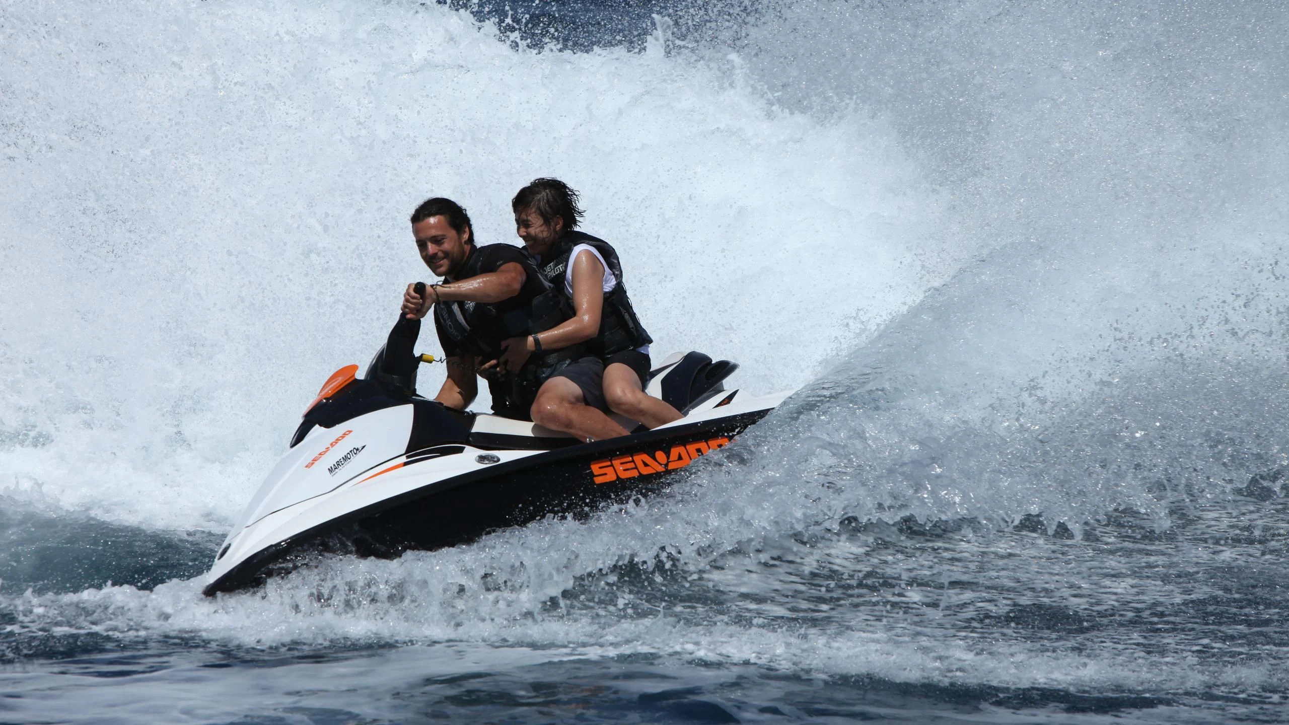 a man and woman riding a jet ski aboard DIONEA Yacht for Sale