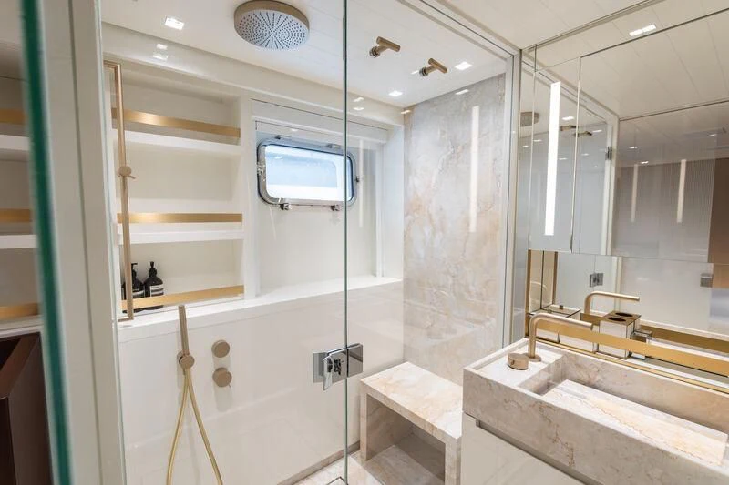 a bathroom with a glass shower aboard ELA & SEA Yacht for Sale