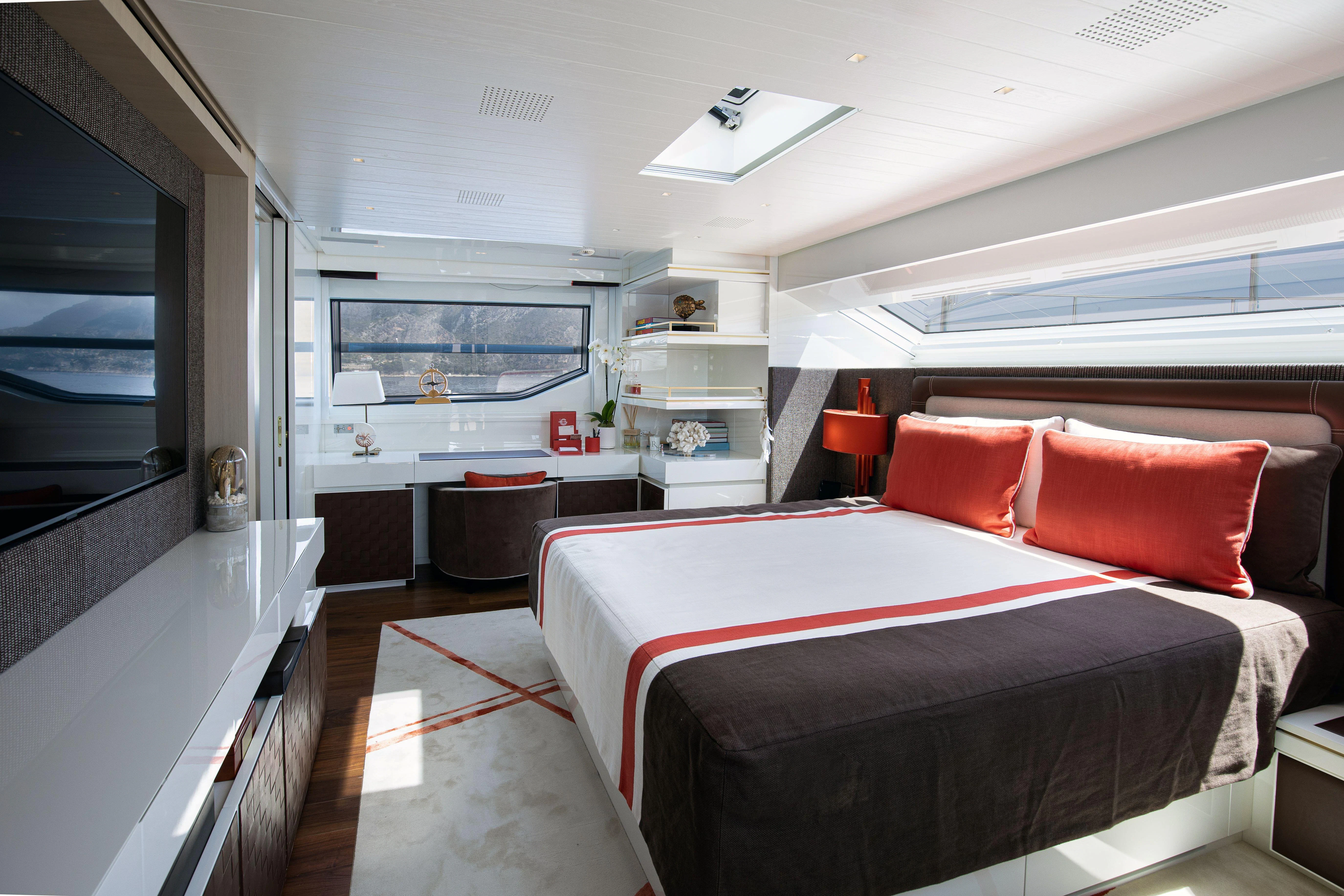 a bedroom with a bed and a tv aboard ELA & SEA Yacht for Sale
