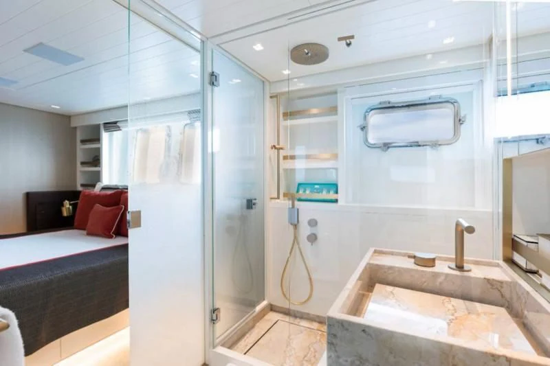 a bathroom with a glass shower aboard ELA & SEA Yacht for Sale