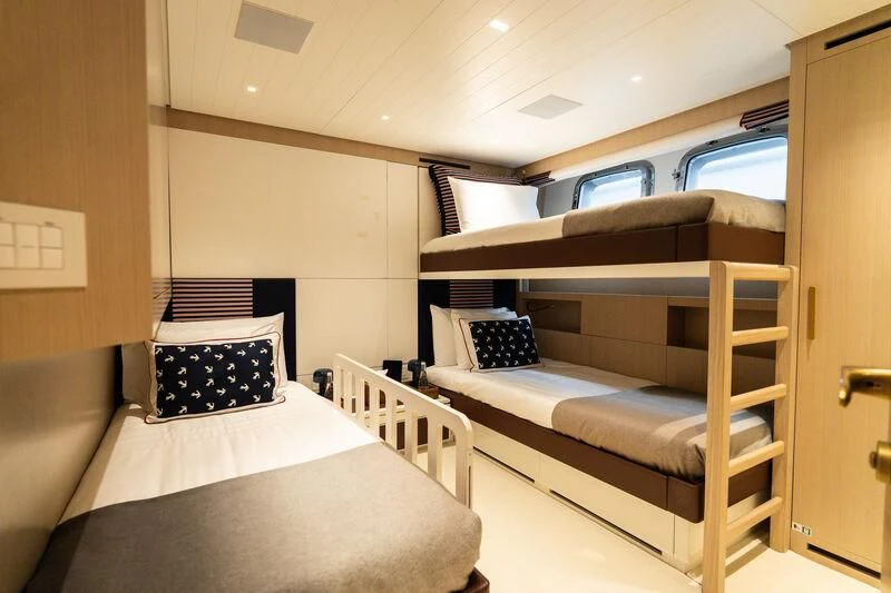 a room with a bed and a bunk bed aboard ELA & SEA Yacht for Sale