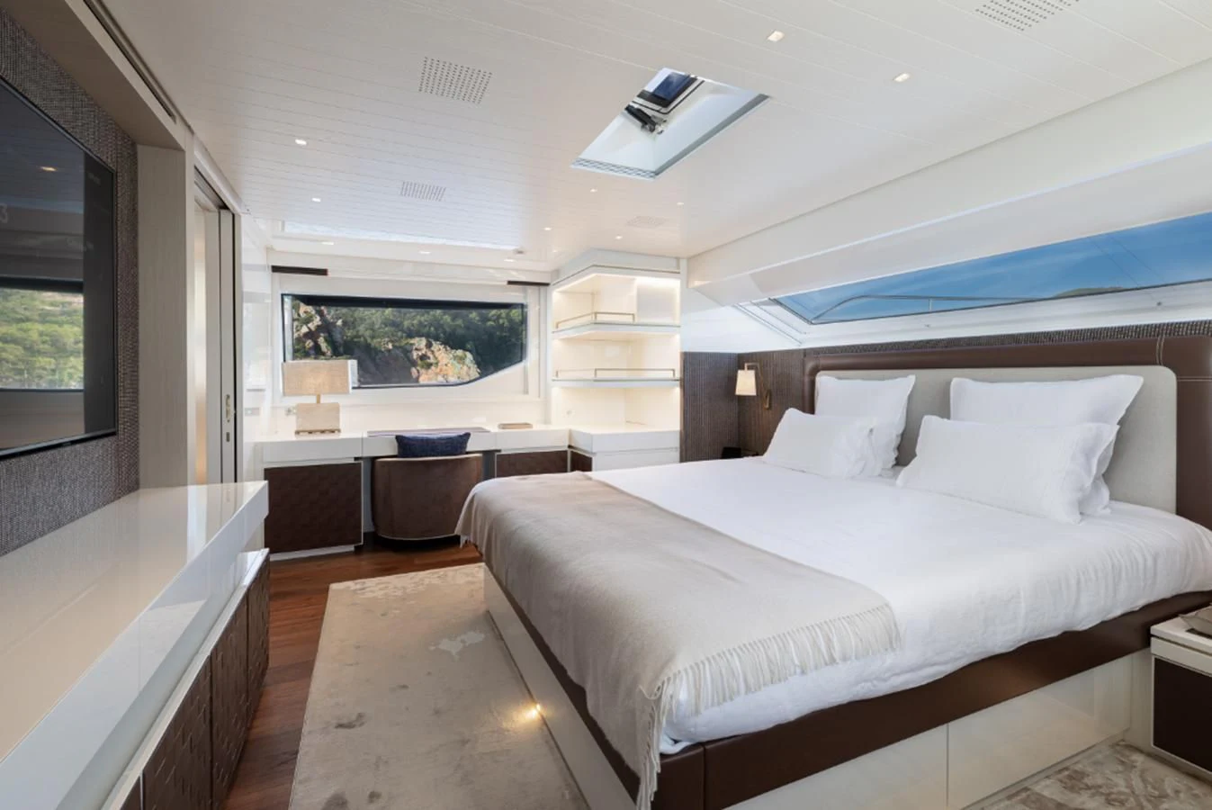 a bedroom with a bed and a desk aboard ELA & SEA Yacht for Sale