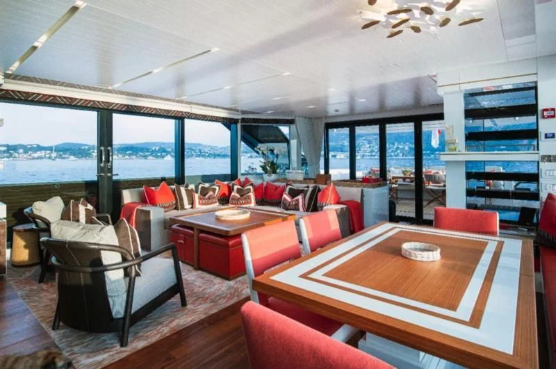 a room with a table and chairs aboard ELA & SEA Yacht for Sale