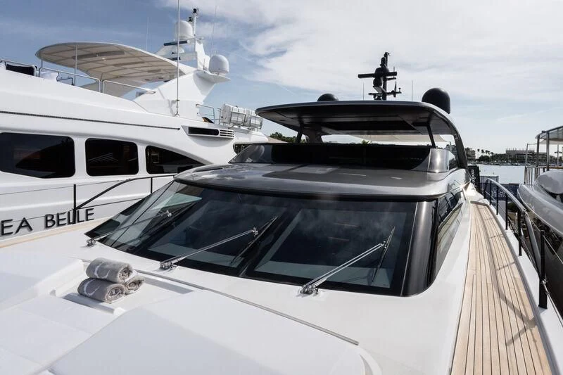 a white yacht with a person standing on the deck aboard ELA & SEA Yacht for Sale