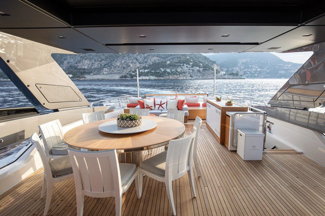 a table and chairs on a deck aboard ELA & SEA Yacht for Sale