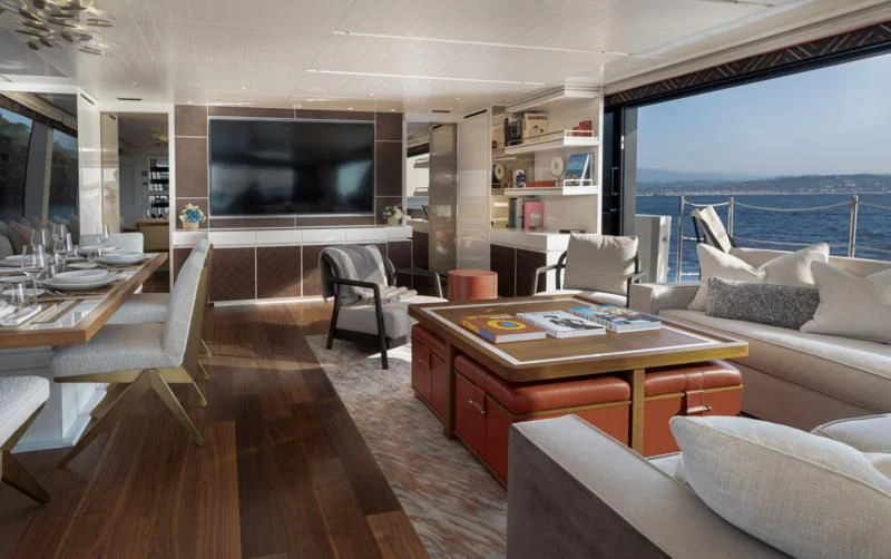 a living room with a table and chairs aboard ELA & SEA Yacht for Sale