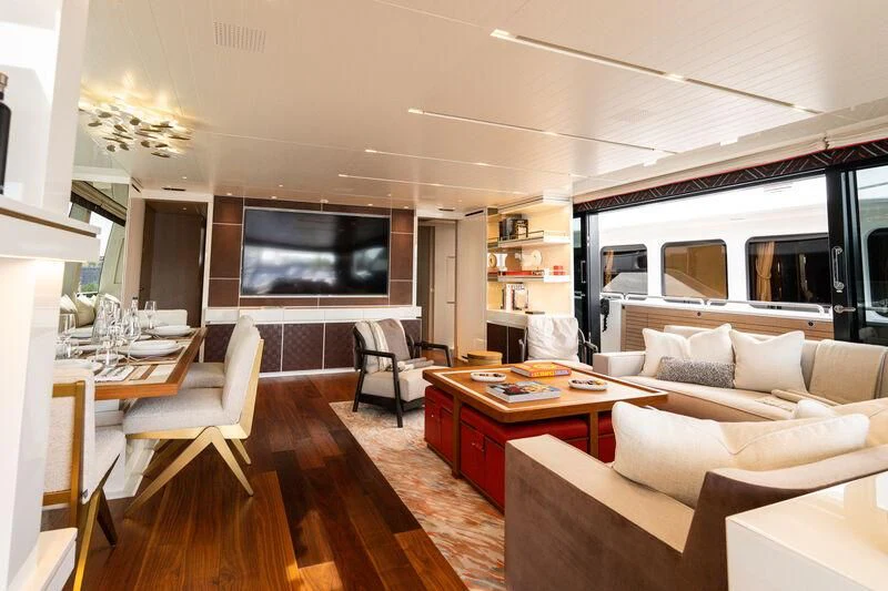 a living room with a tv and furniture aboard ELA & SEA Yacht for Sale