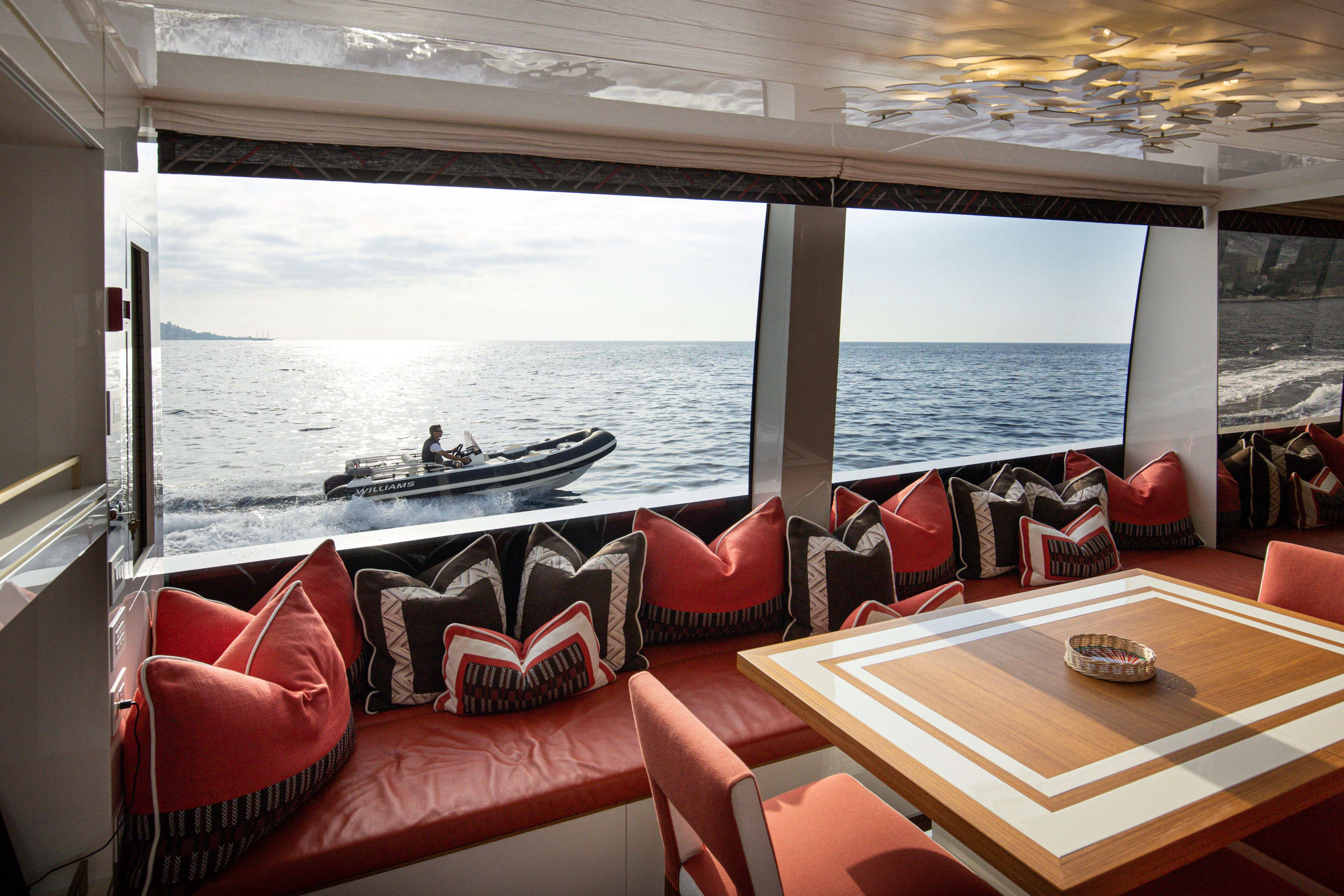 a room with a table and chairs aboard ELA & SEA Yacht for Sale