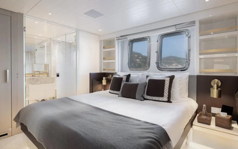 a bedroom with a bed and a mirror aboard ELA & SEA Yacht for Sale