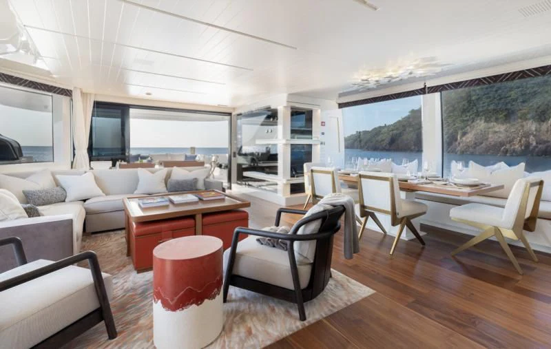 a living room with a large window aboard ELA & SEA Yacht for Sale