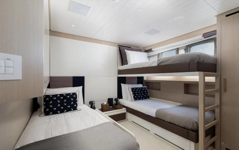a room with two beds aboard ELA & SEA Yacht for Sale
