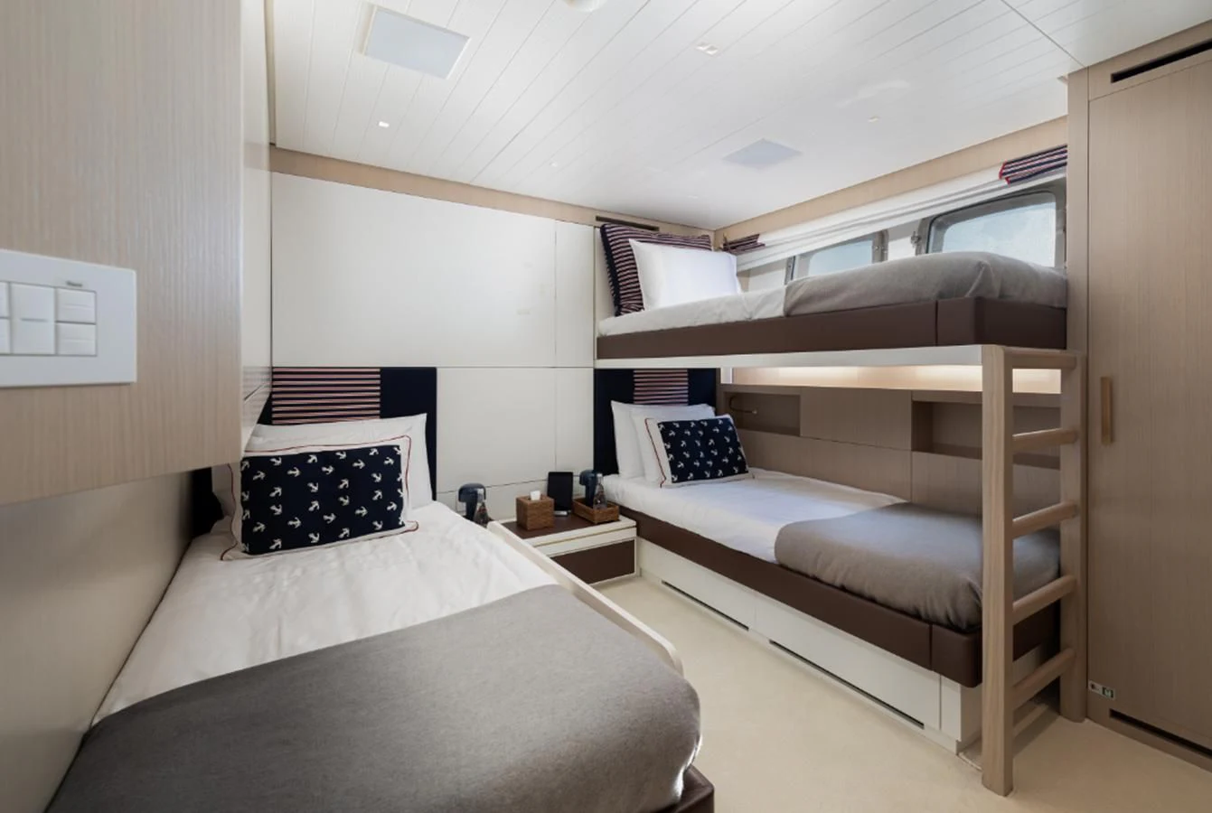 a room with two beds aboard ELA & SEA Yacht for Sale