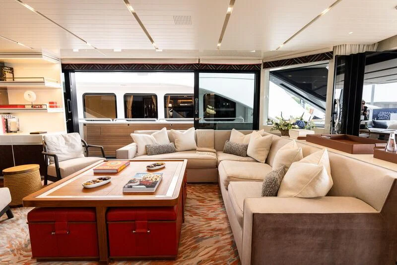 a living room with a couch and a table aboard ELA & SEA Yacht for Sale