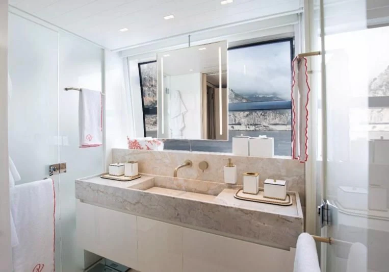 a bathroom with a large mirror aboard ELA & SEA Yacht for Sale