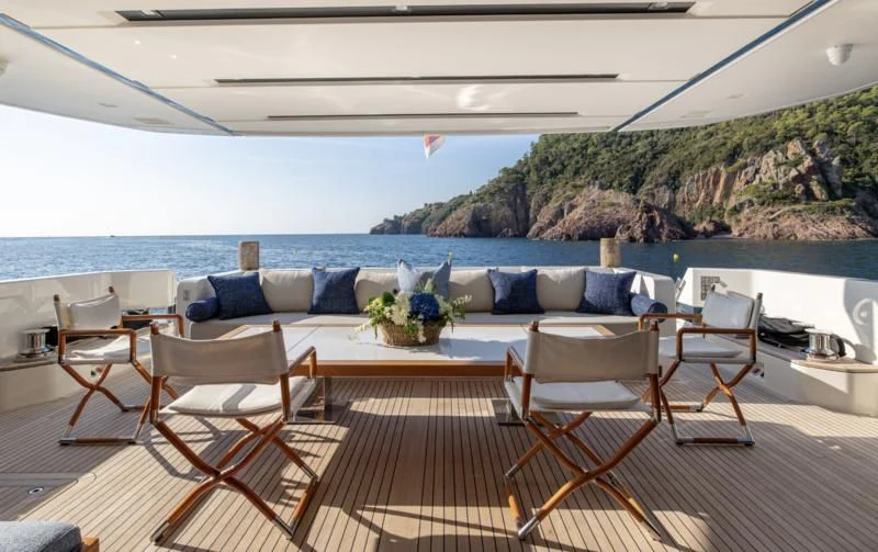 a patio with chairs and a table on it aboard ELA & SEA Yacht for Sale