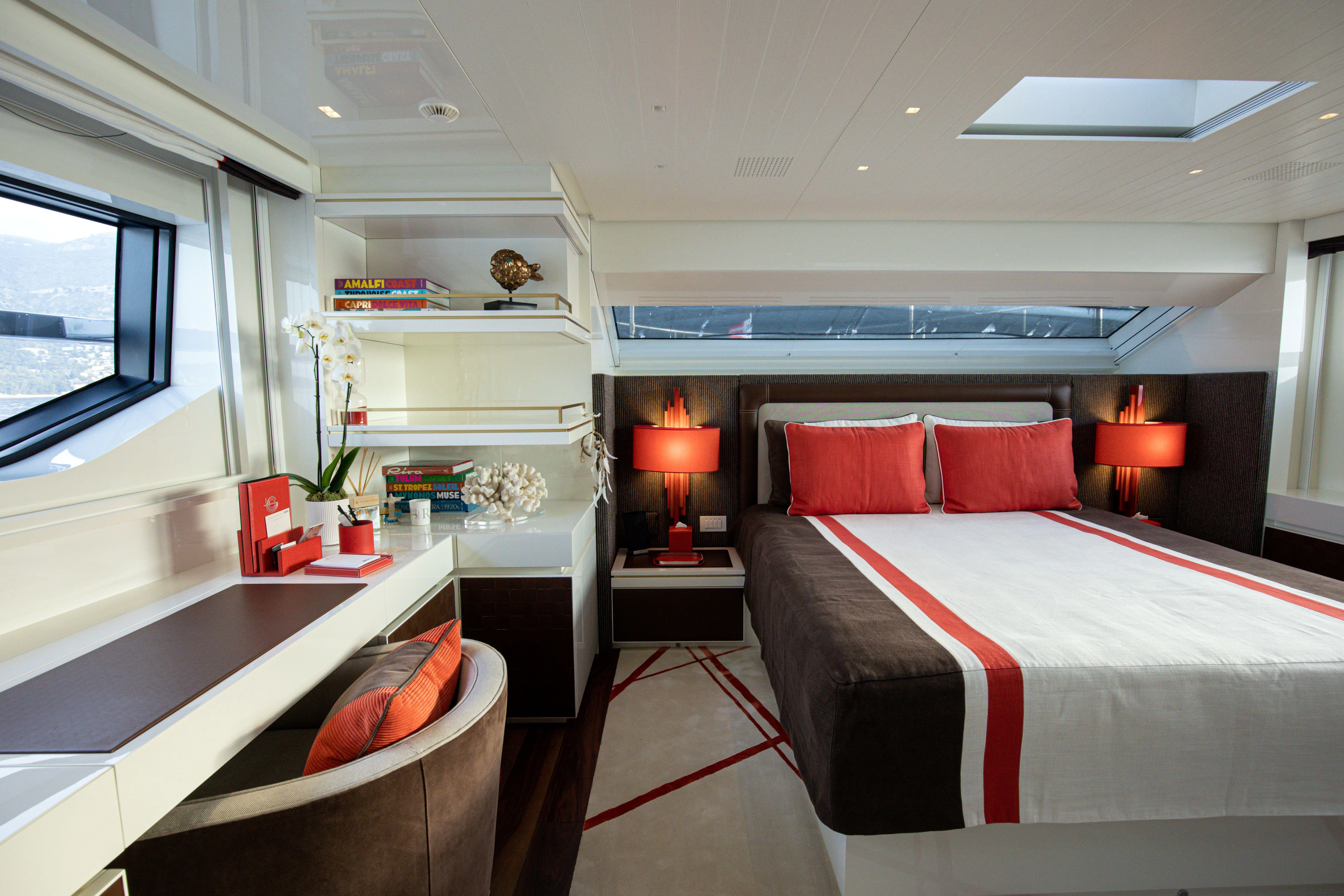 a bedroom with a bed and a desk aboard ELA & SEA Yacht for Sale
