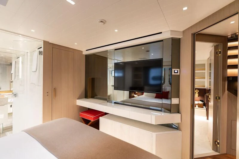 a room with a bed and a tv aboard ELA & SEA Yacht for Sale