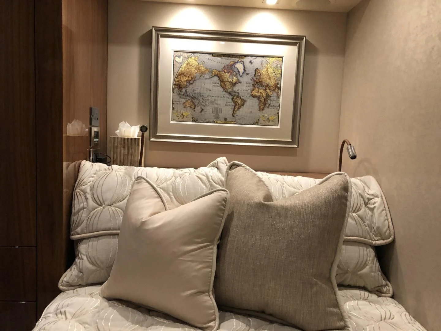 a white couch with a painting on it aboard AFTER MIDNIGHT Yacht for Sale