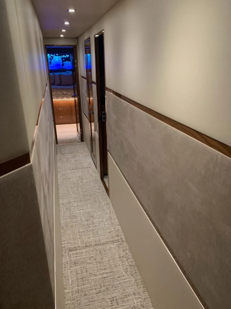 a hallway with a door and a window aboard AFTER MIDNIGHT Yacht for Sale