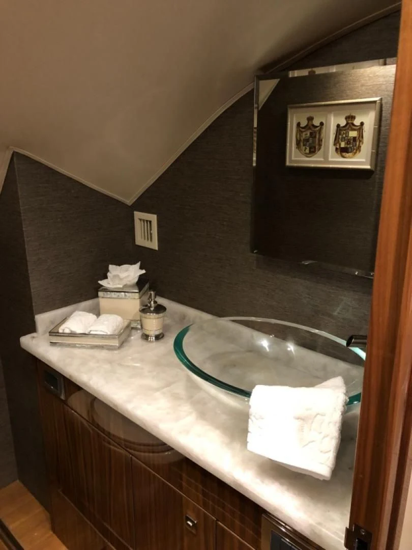 a bathroom with a sink and a mirror aboard AFTER MIDNIGHT Yacht for Sale