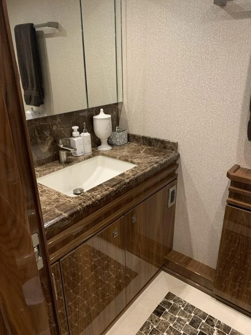 a bathroom with a sink and a mirror aboard AFTER MIDNIGHT Yacht for Sale